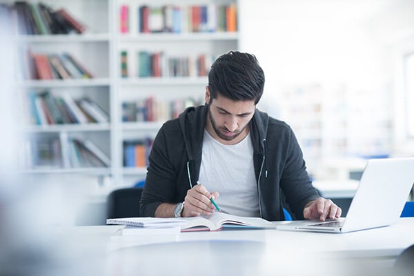 vecteezy_student-in-school-library-using-laptop-for-research_31050107